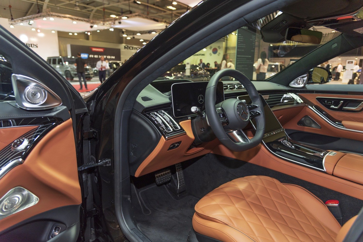 Luxury car interior with leather seats, digital displays, and modern controls