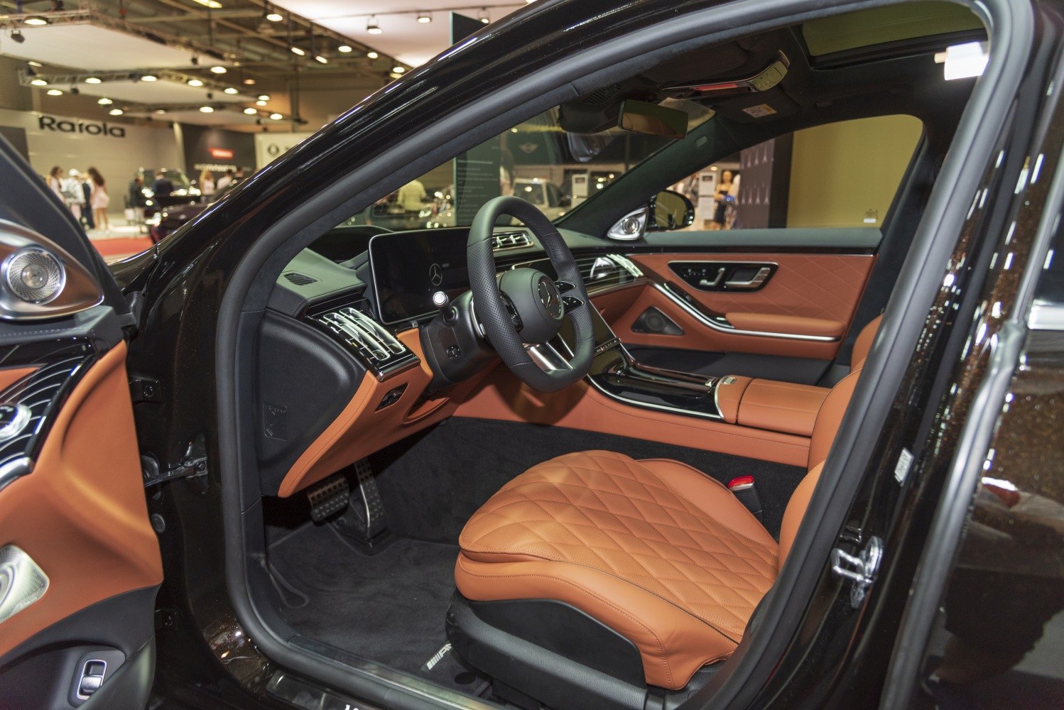Brown quilted leather seats with a digital dashboard and modern controls
