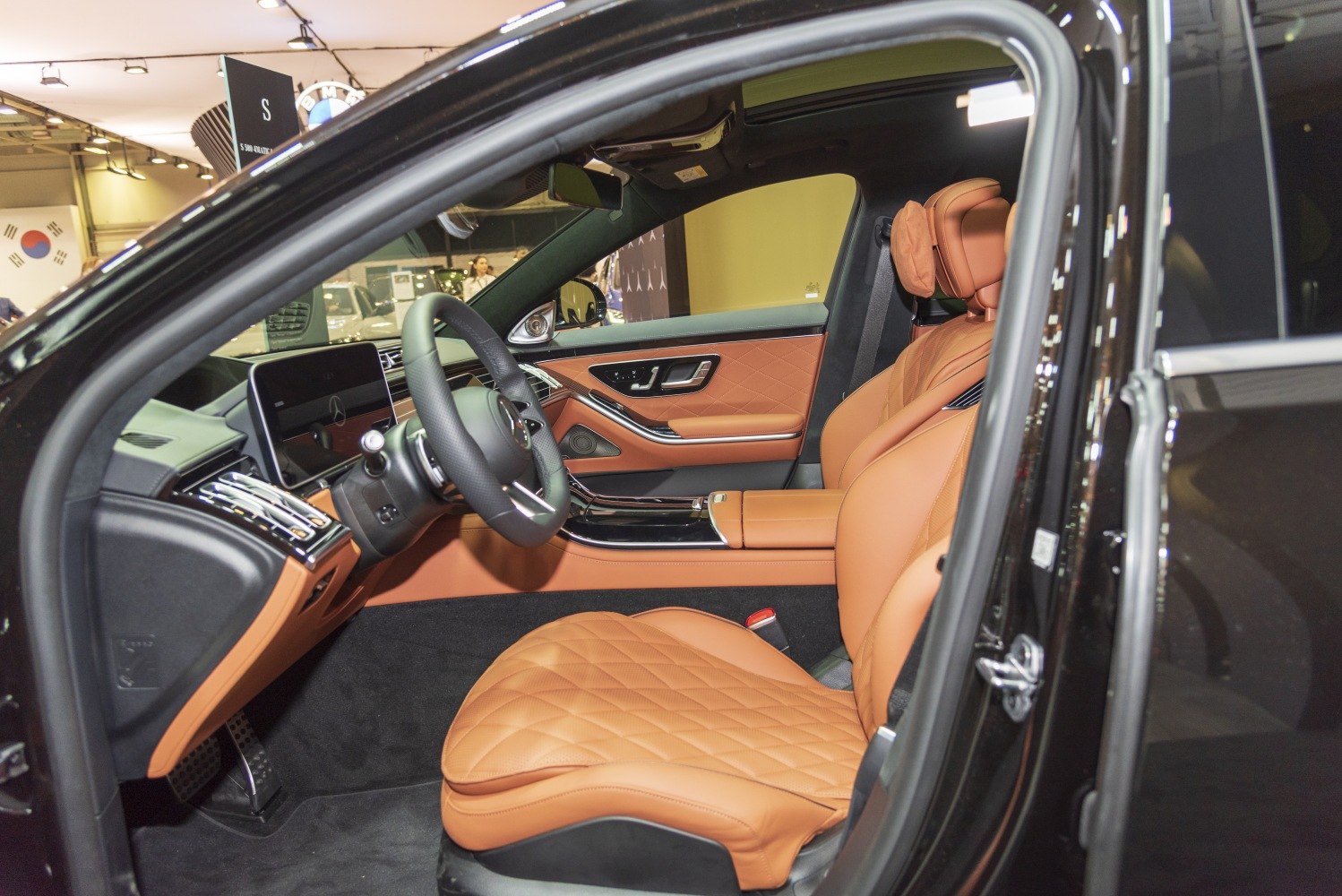 Quilted tan leather seats and modern dashboard with digital display