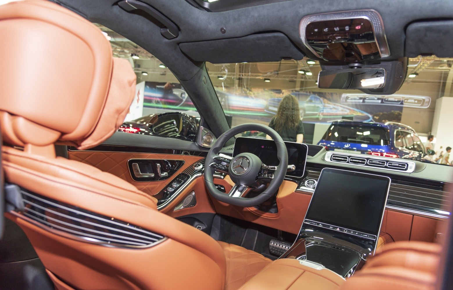 Tan leather seats with digital dashboard and high-tech steering wheel