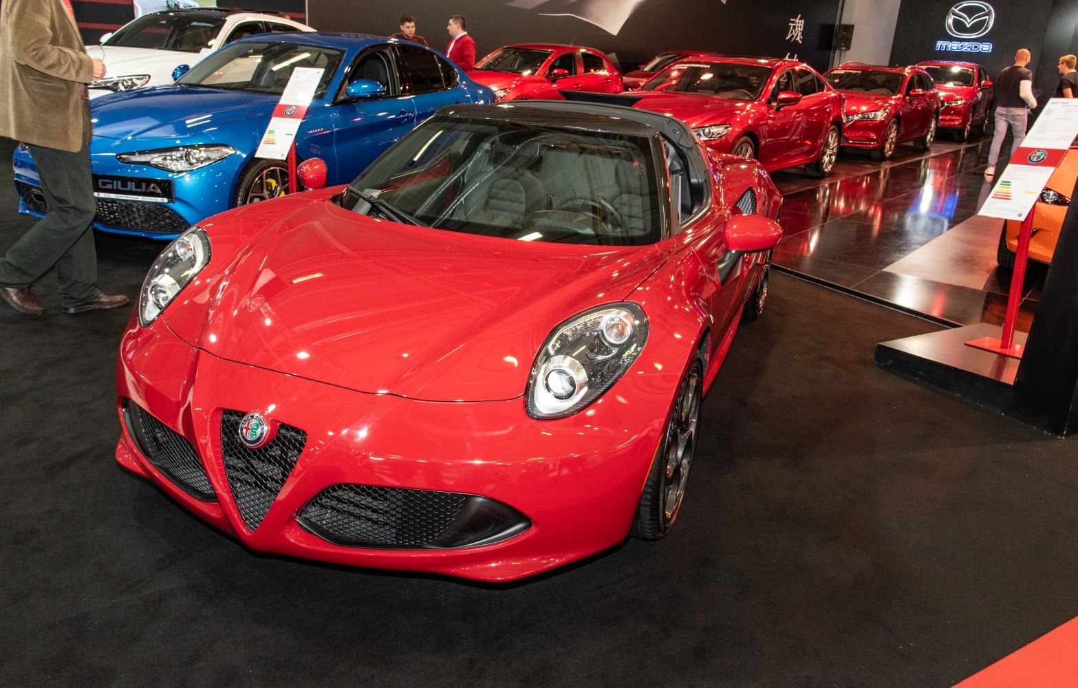 Red sports coupe with distinctive headlights and aggressive aerodynamic front fascia
