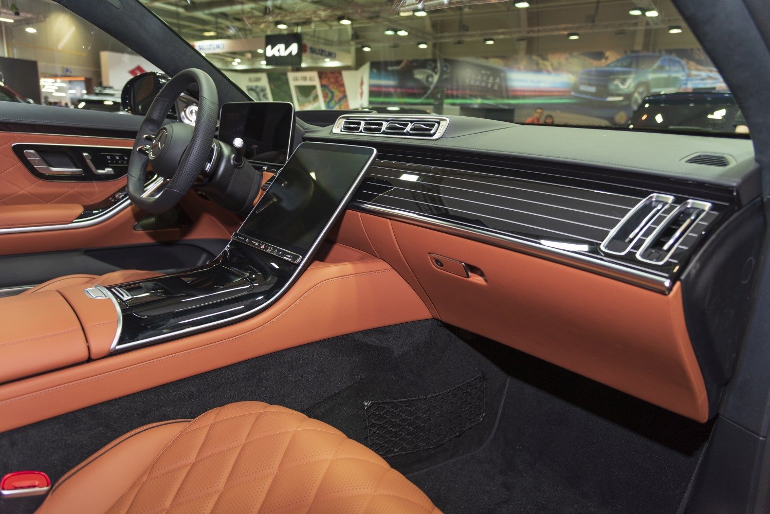 Luxury leather seats and advanced infotainment system in a modern car interior.