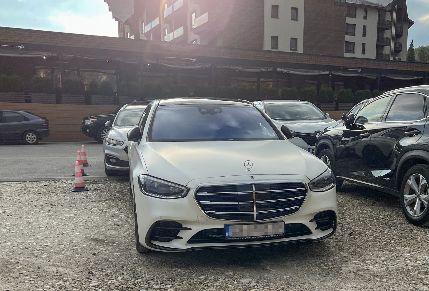 Front view of a luxury sedan with a distinctive grille and LED headlights