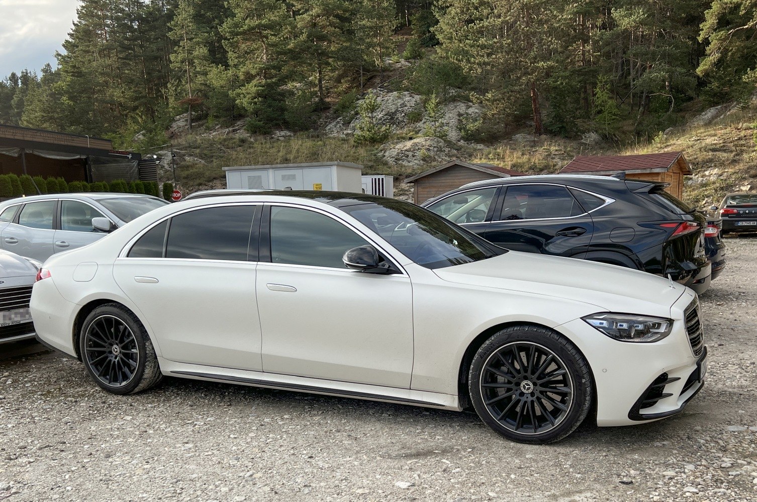 White luxury sedan with tinted windows and black multi-spoke rims