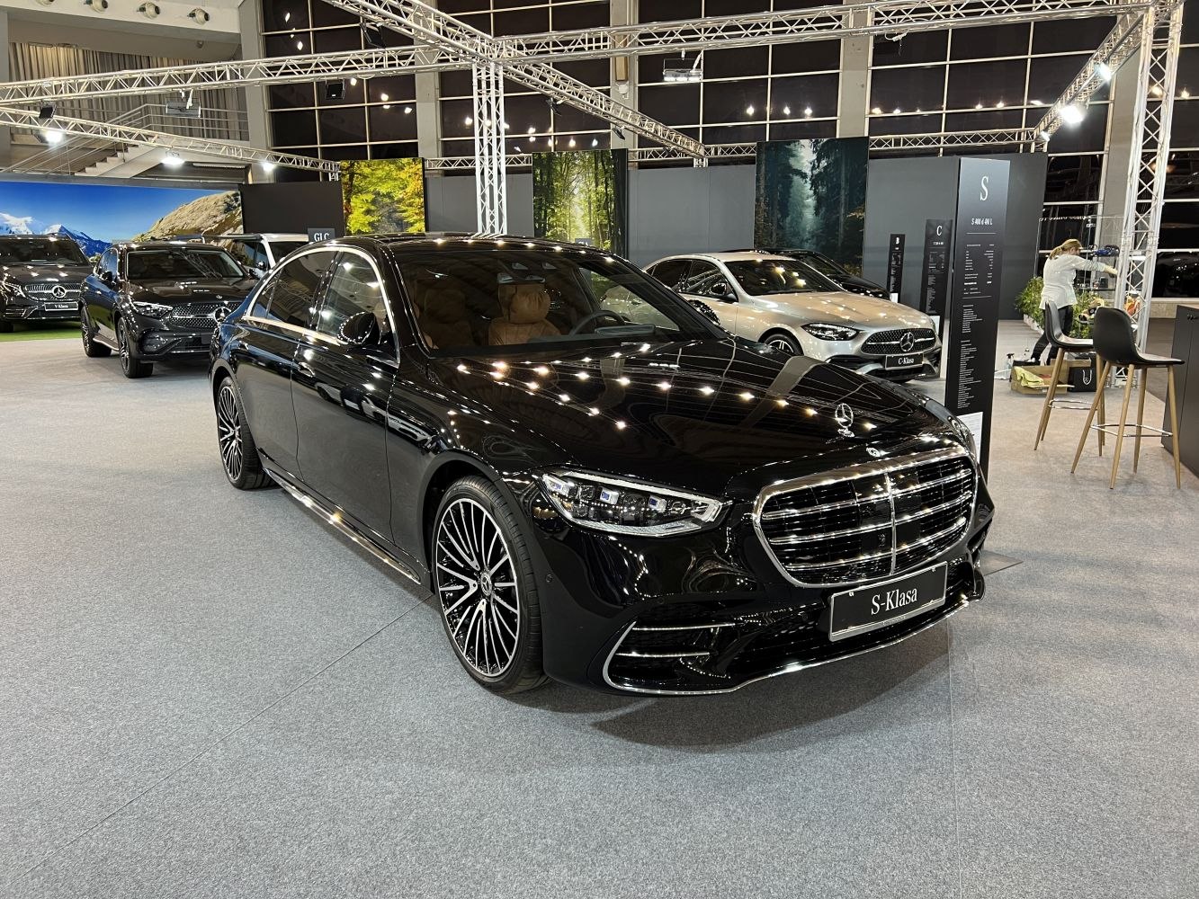 Luxury sedan front with distinctive grille and multi-spoke alloy wheels