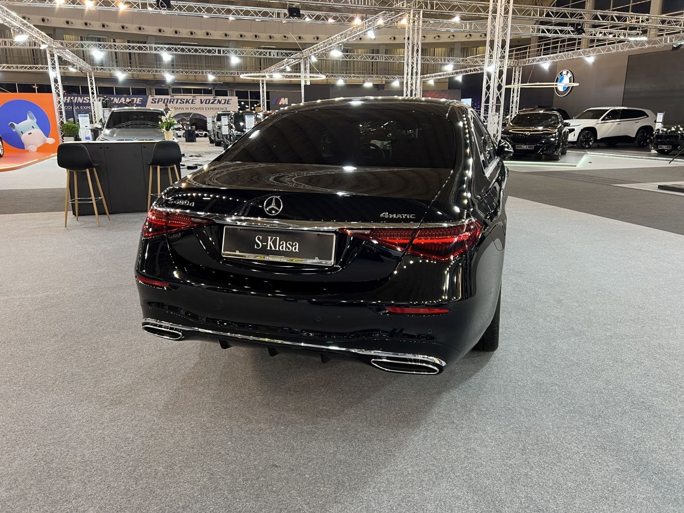 Luxury sedan rear with LED tail lights and dual chrome exhaust