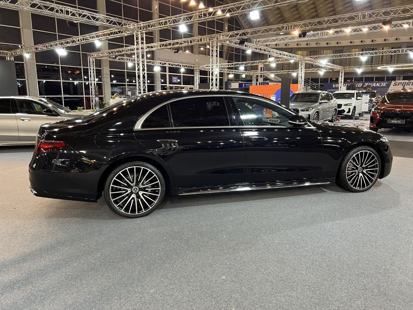 Black luxury sedan with distinctive multi-spoke alloy wheels and tinted windows.