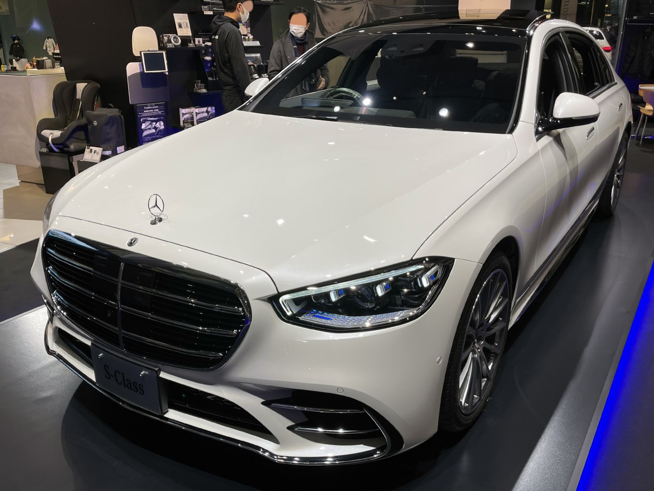 Front grille and LED headlights of a luxury sedan in white