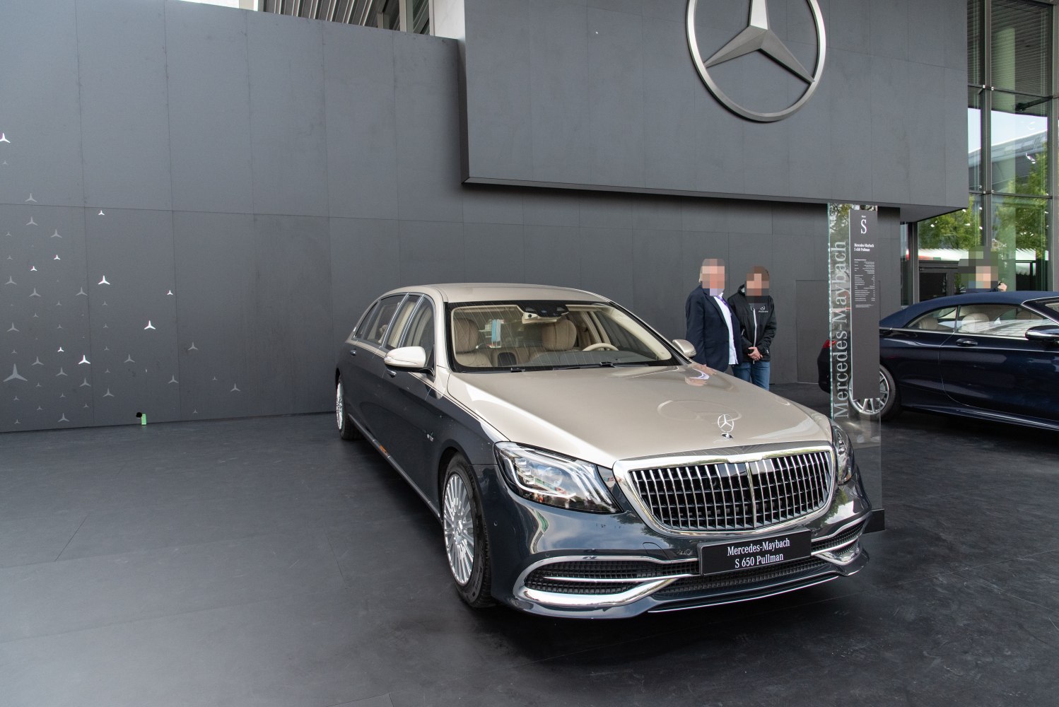 Luxury extended sedan with prominent grille and two-tone paint