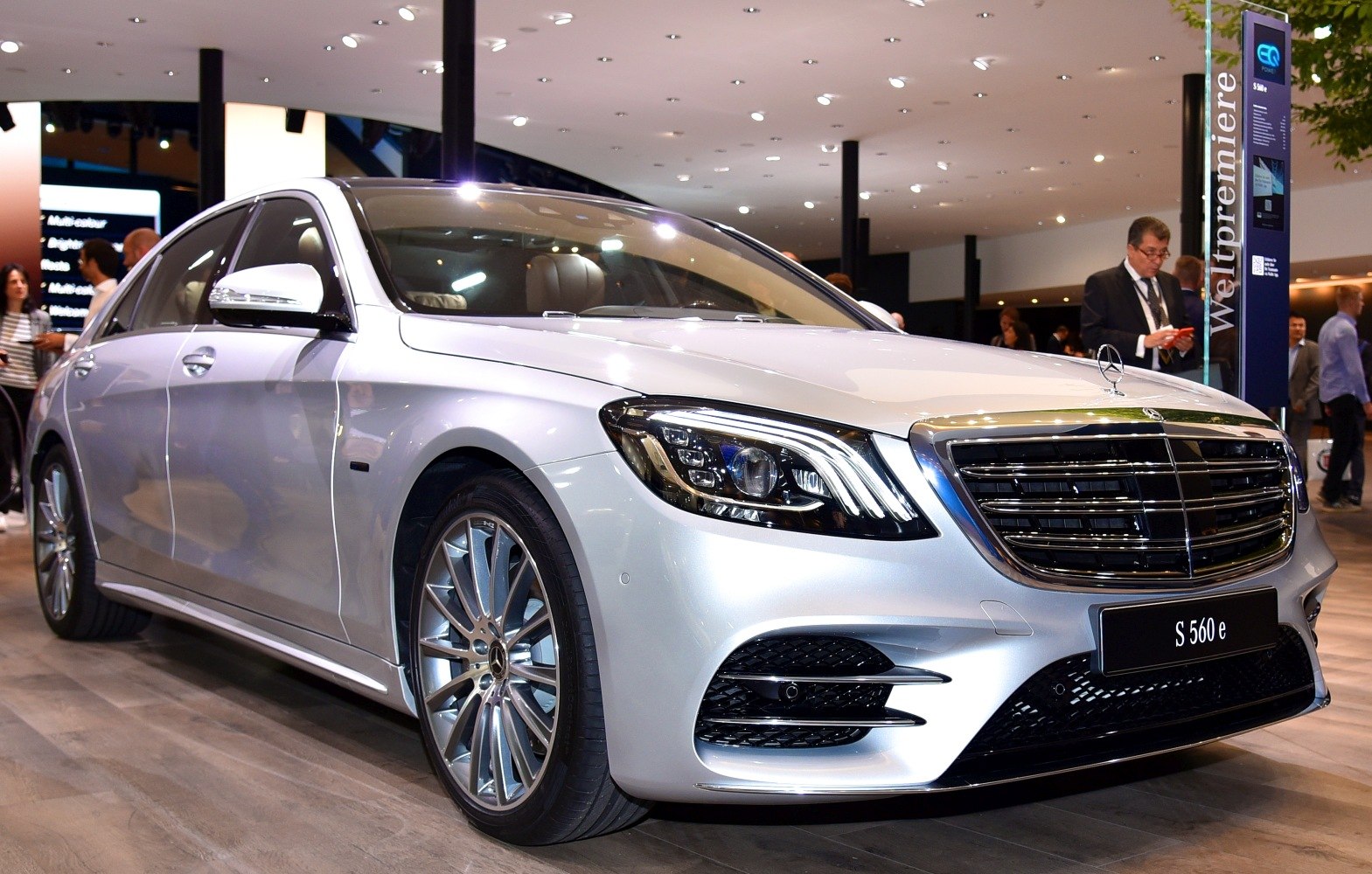 Front view of luxury sedan with LED headlights and chrome grille