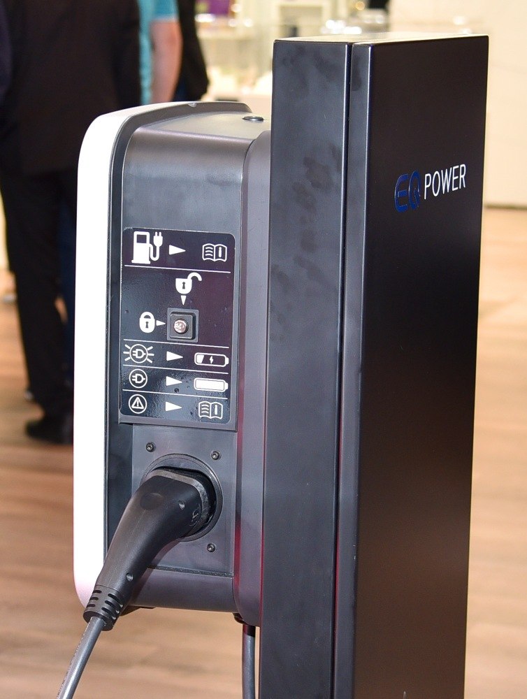Electric charging station with EQ Power branding and plug-in connector.