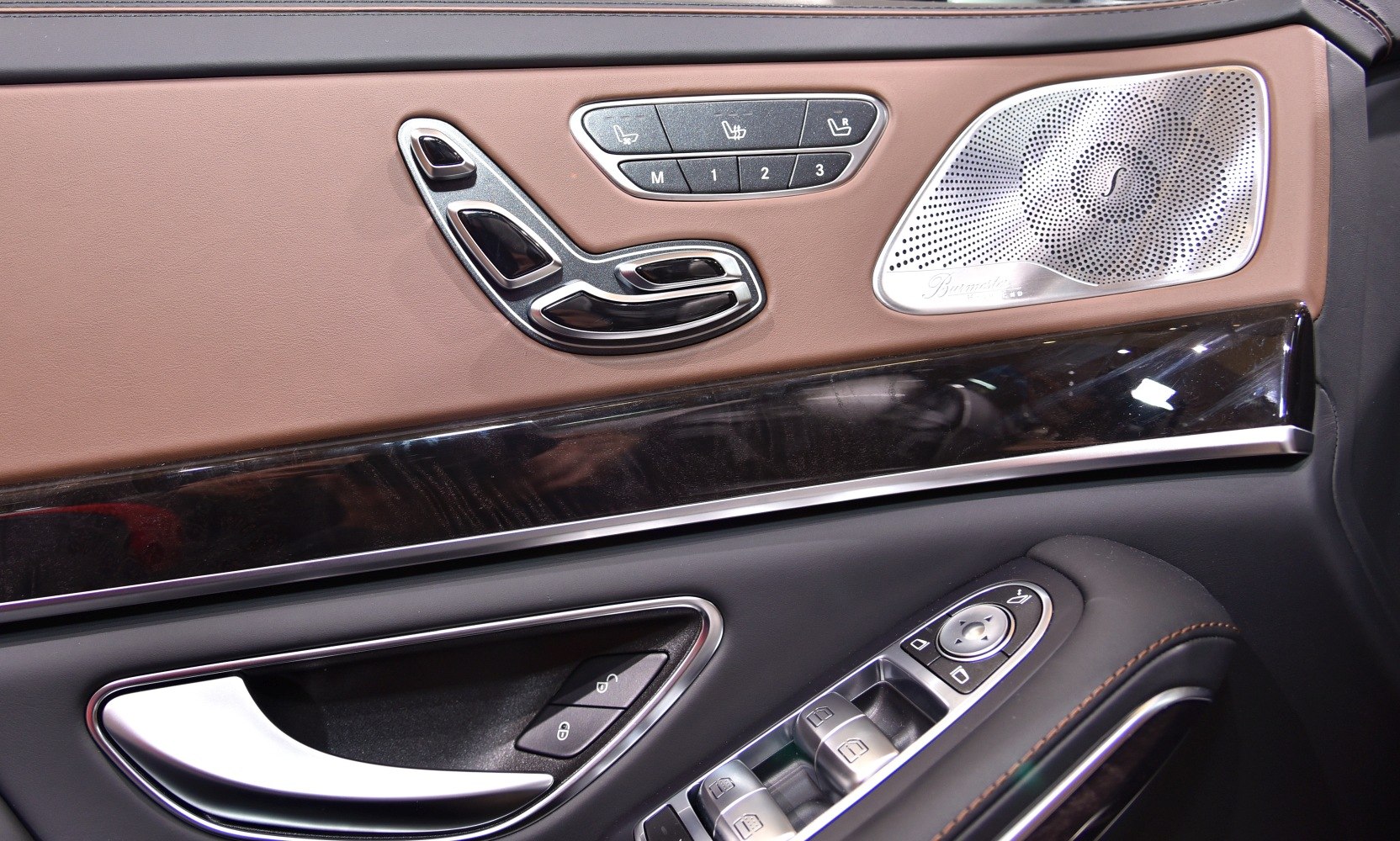 Luxury car interior door panel with seat controls and Burmester speaker