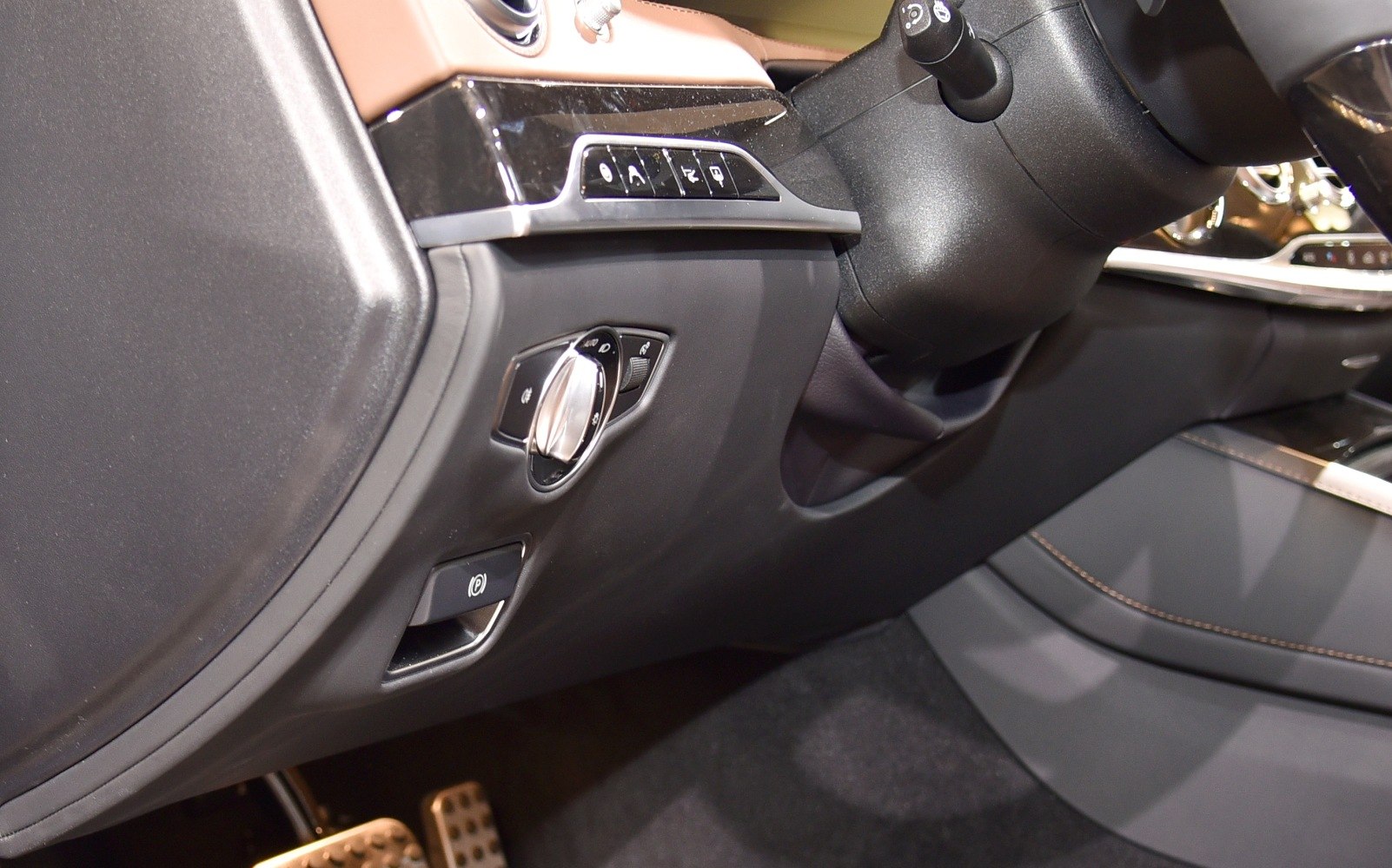Interior controls with lighting switch and parking brake button near dashboard