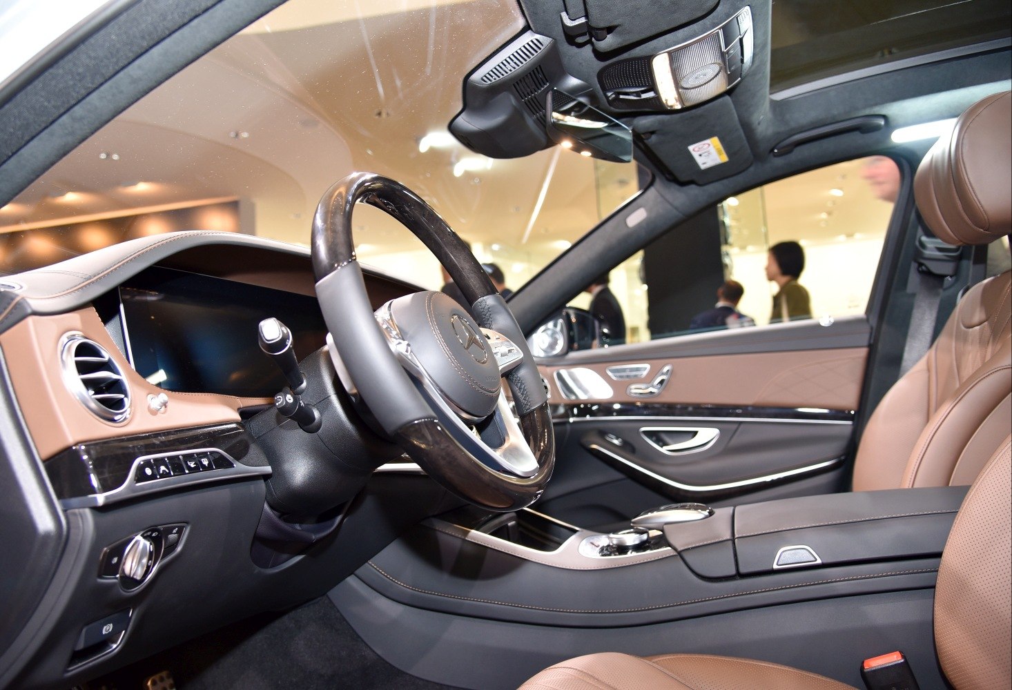 Luxury interior with steering wheel, dashboard, control buttons, and leather seats