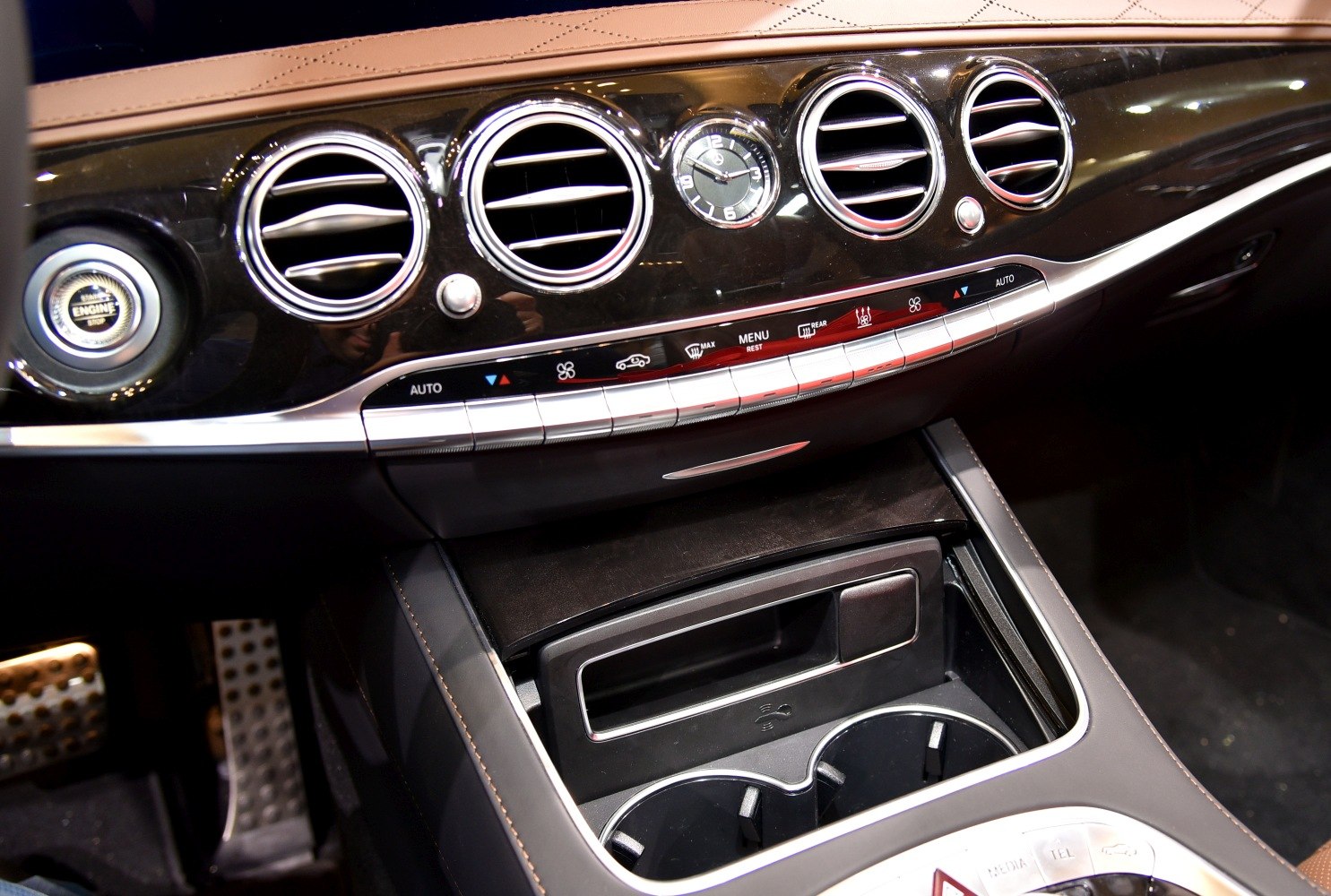 Classic dashboard air vents, analog clock, and climate control panel