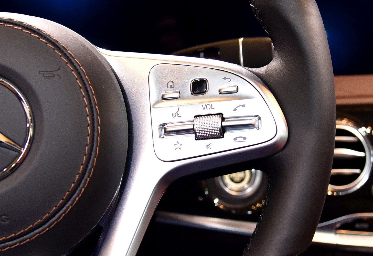 Steering wheel volume control and call buttons close-up