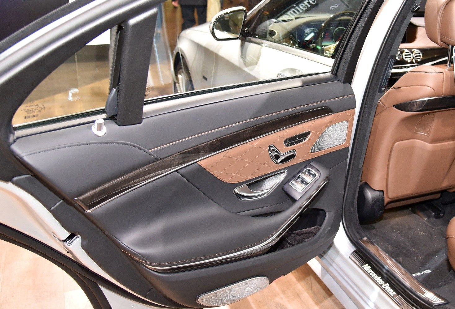 Luxury car interior door panel with wood trim and control buttons