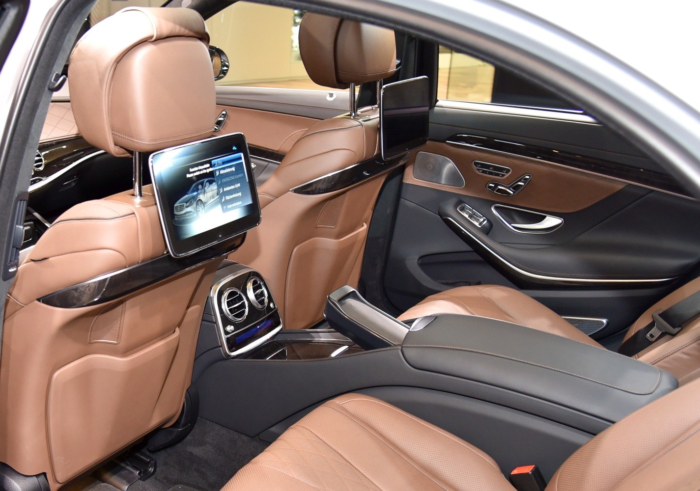 Rear seat luxury interior with integrated entertainment screens and leather upholstery