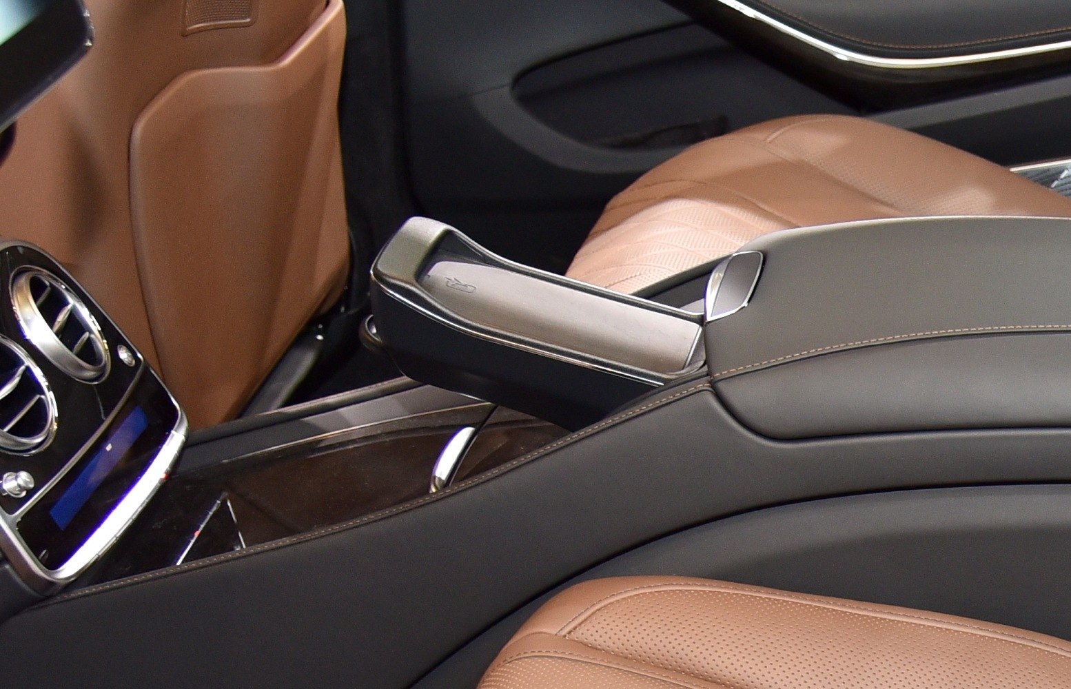 Leather upholstery and center console armrest with perforated seats