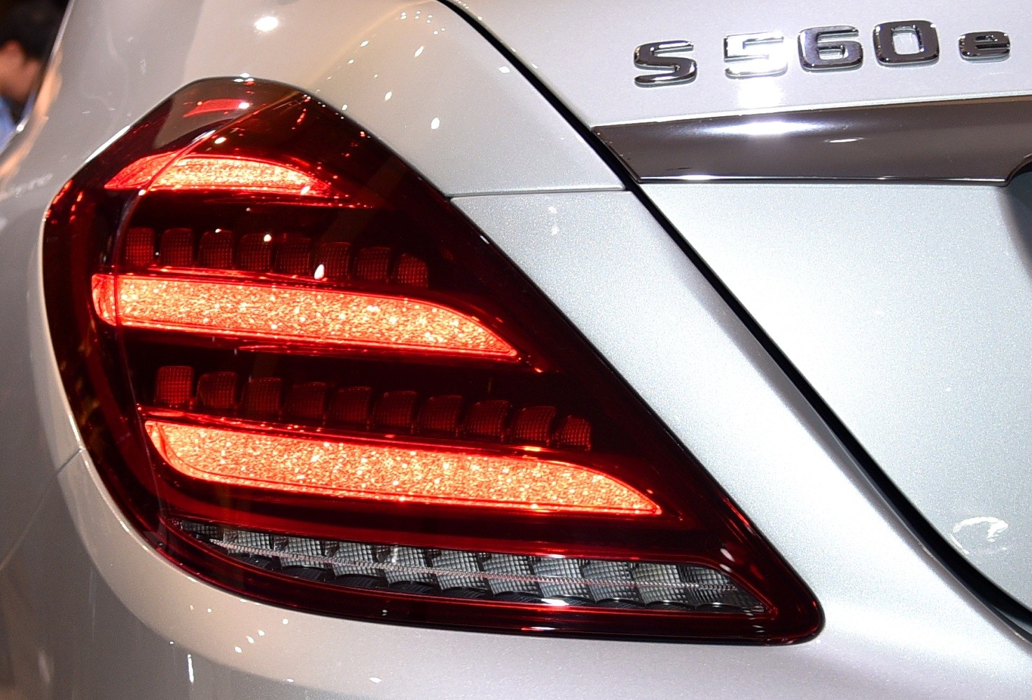 Rear LED taillight with horizontal light bars and chrome trim.