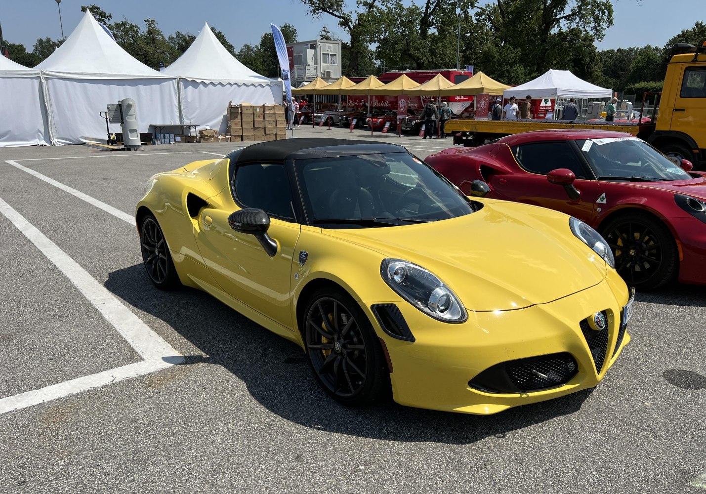 Yellow convertible sports car with black wheels and aerodynamic design