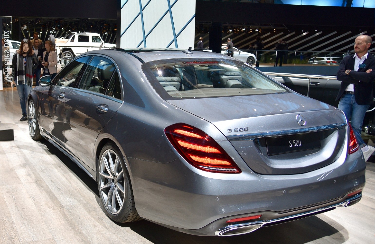Rear view of luxury sedan with sleek taillights and dual chrome exhausts