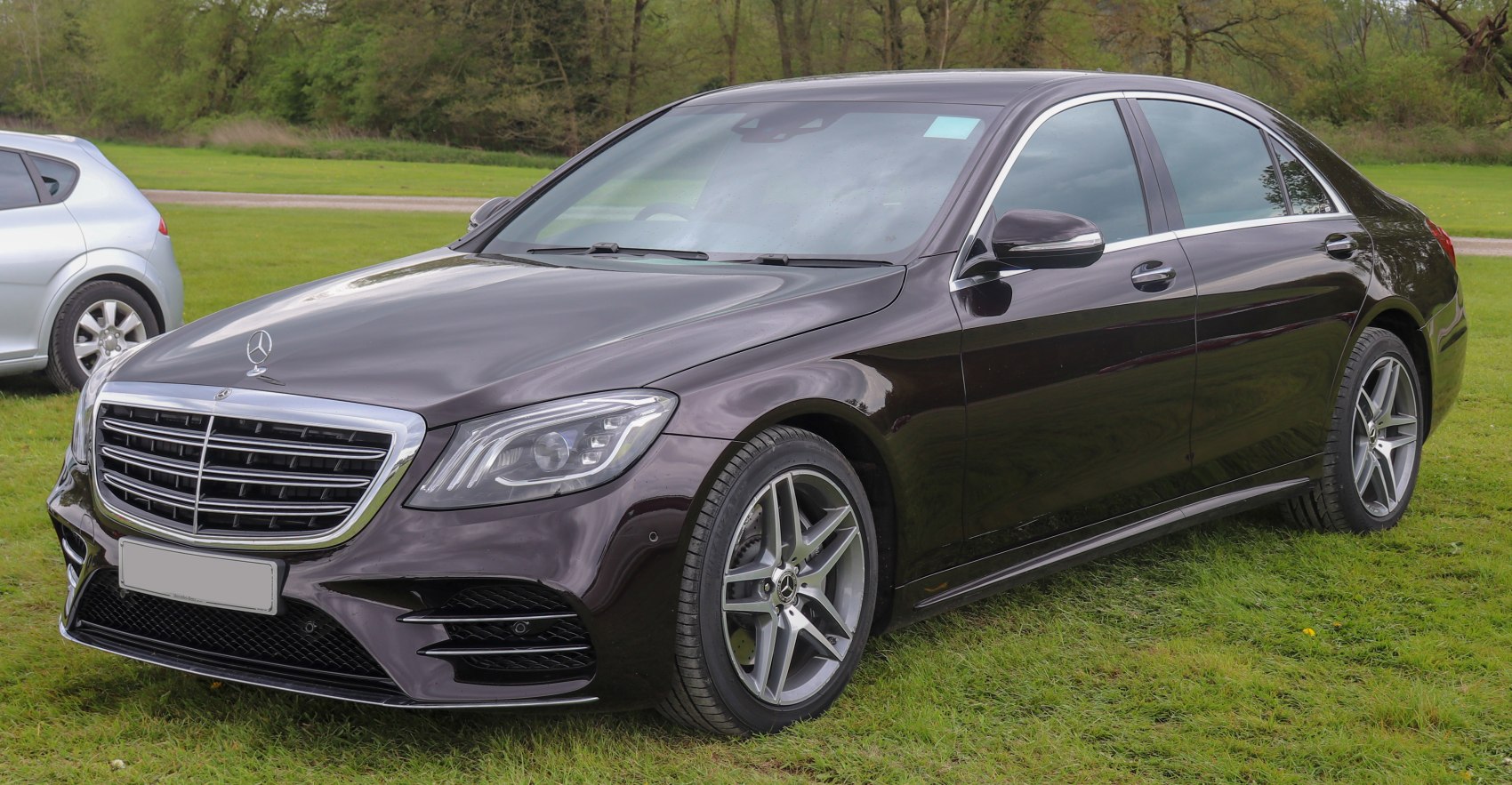 Luxury black sedan with AMG alloy wheels and LED headlights