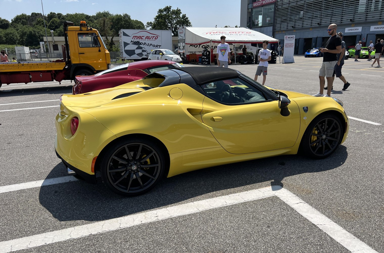 Yellow roadster with carbon fiber roof and black wheels