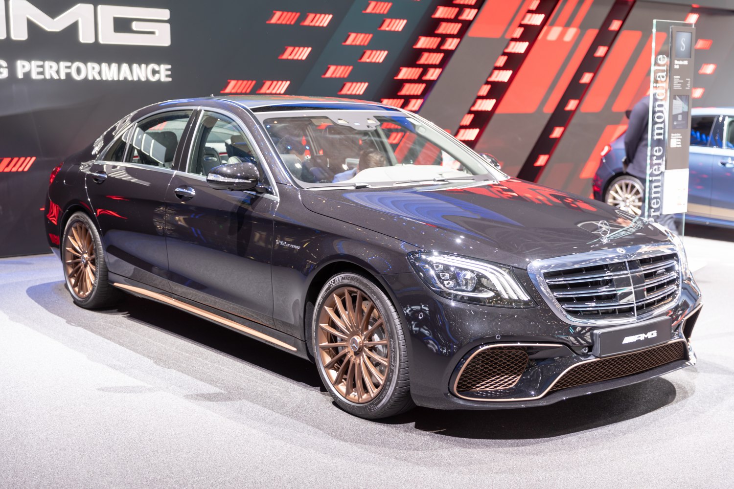 Black luxury sedan with AMG styling and bronze multi-spoke wheels