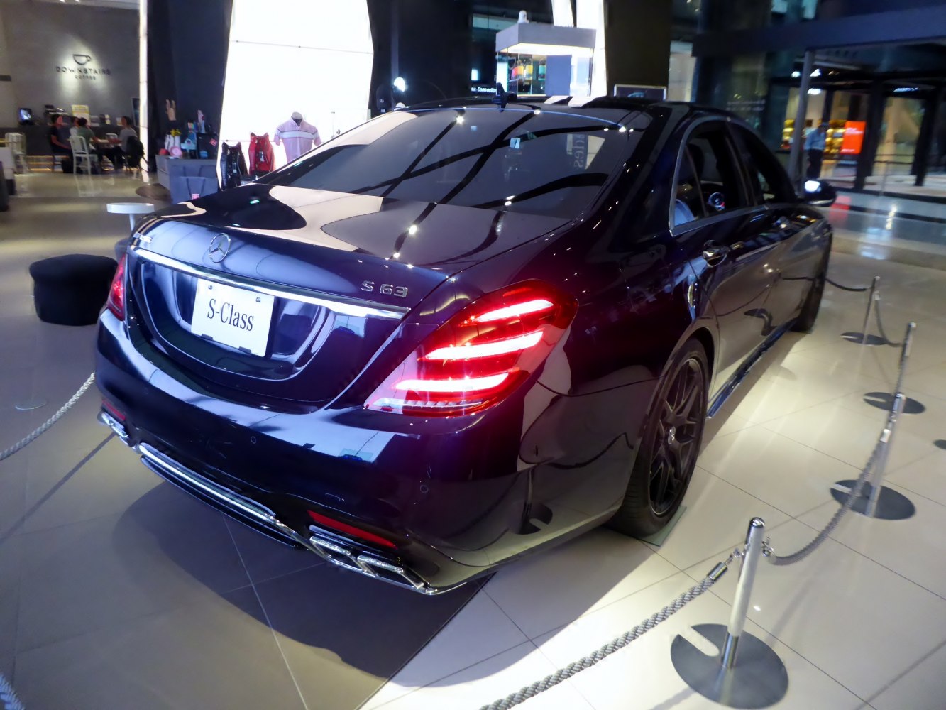 Luxury sedan rear view with LED taillights and quad exhausts