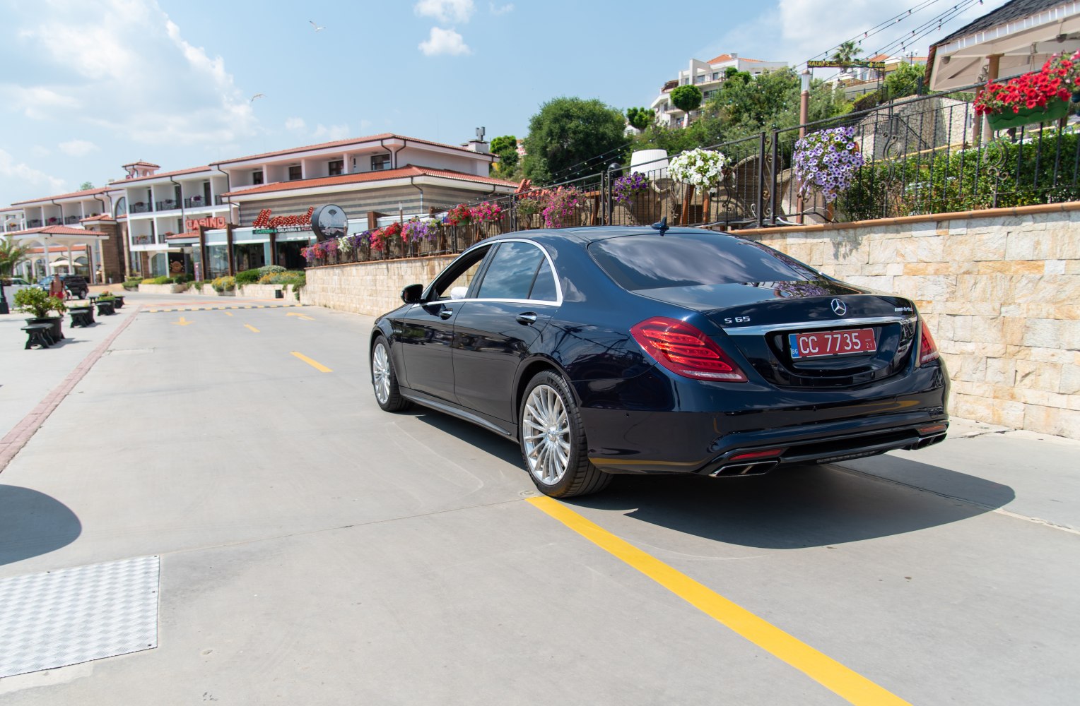 Rear three-quarter view of luxury sedan with distinctive taillights and chrome trim