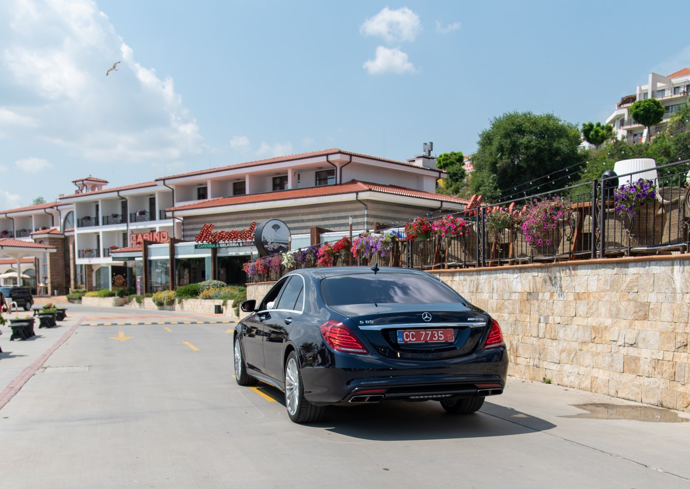 Luxury sedan rear with bold taillights and quad exhaust tips