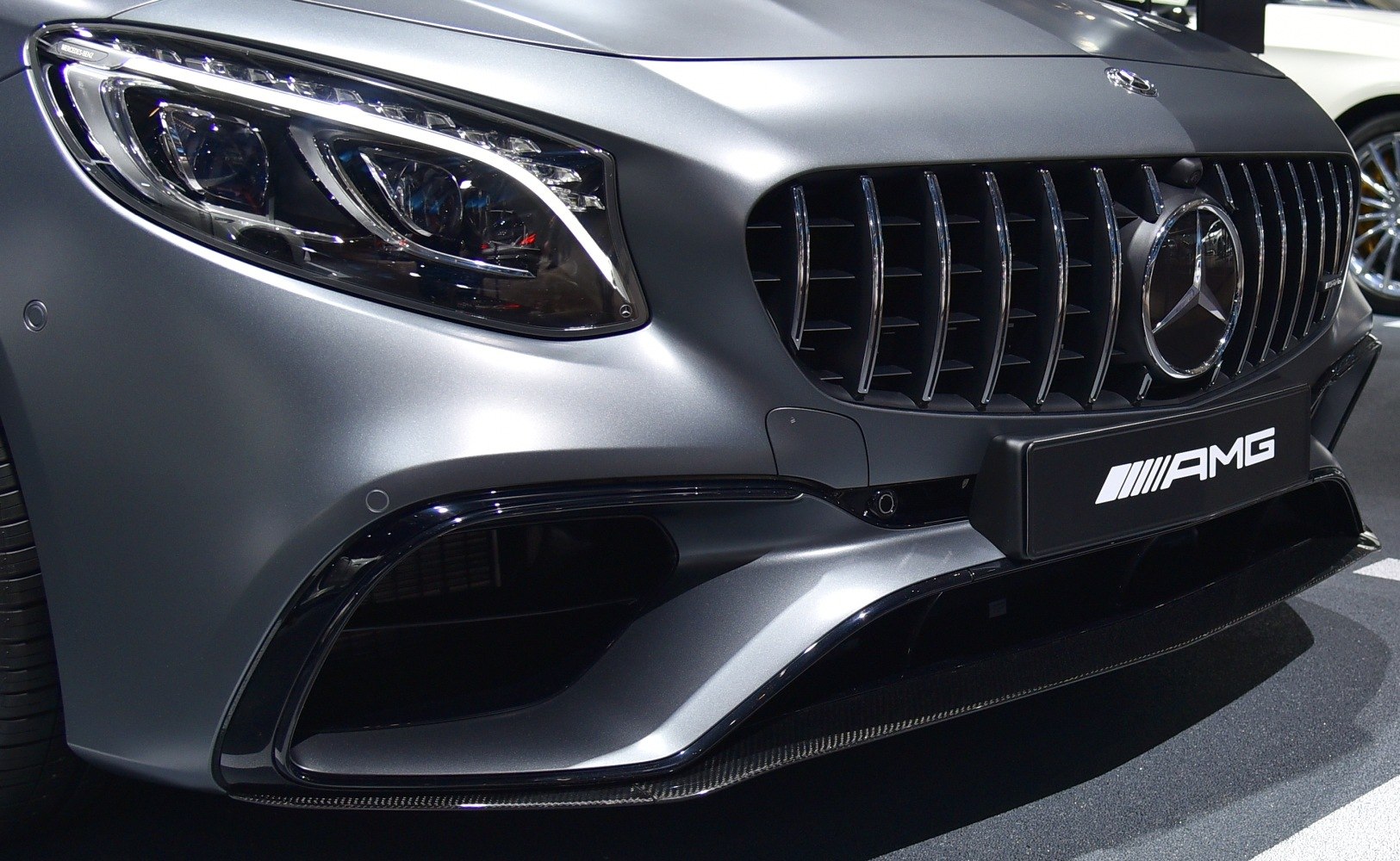 Close-up of front grille and LED headlight with AMG emblem