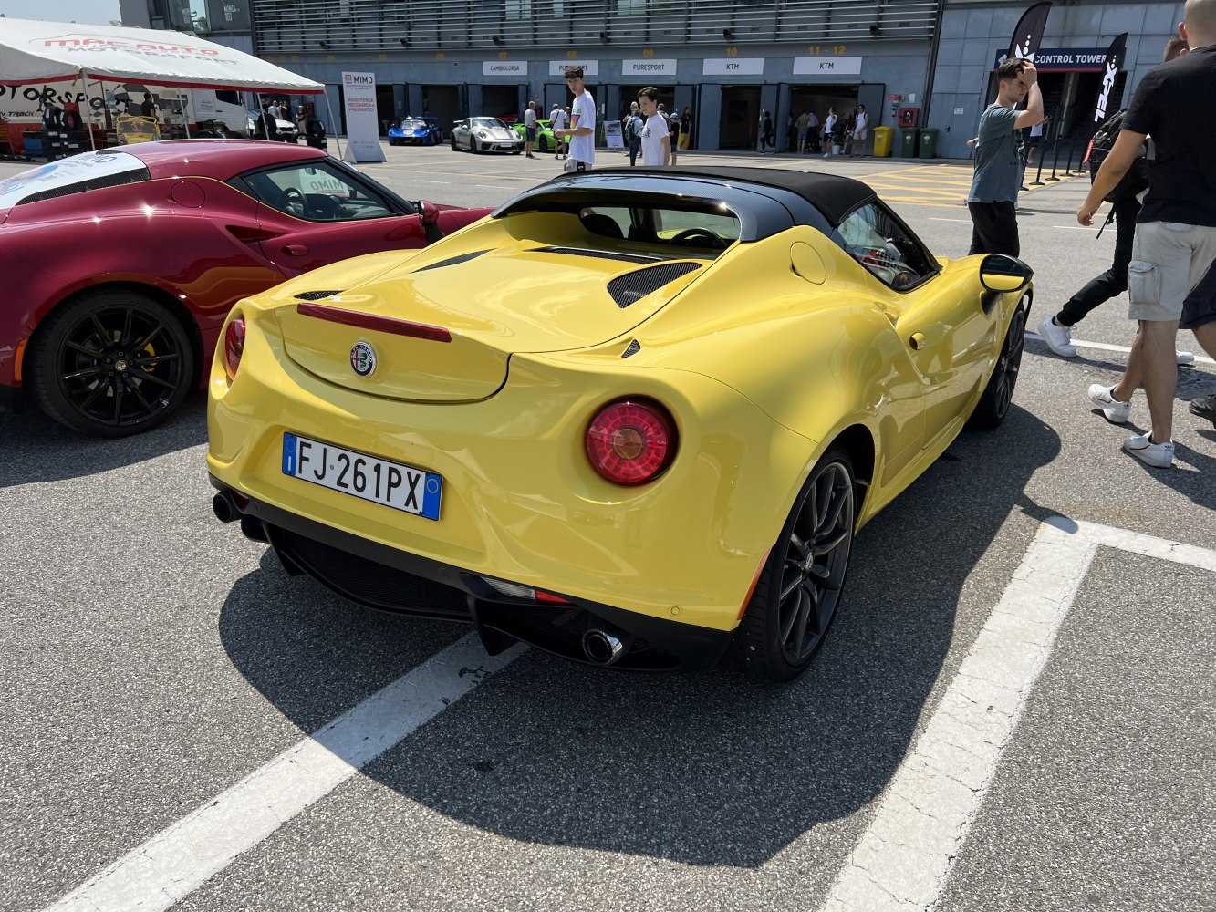 Rear view of a sporty convertible with round taillights and dual exhaust