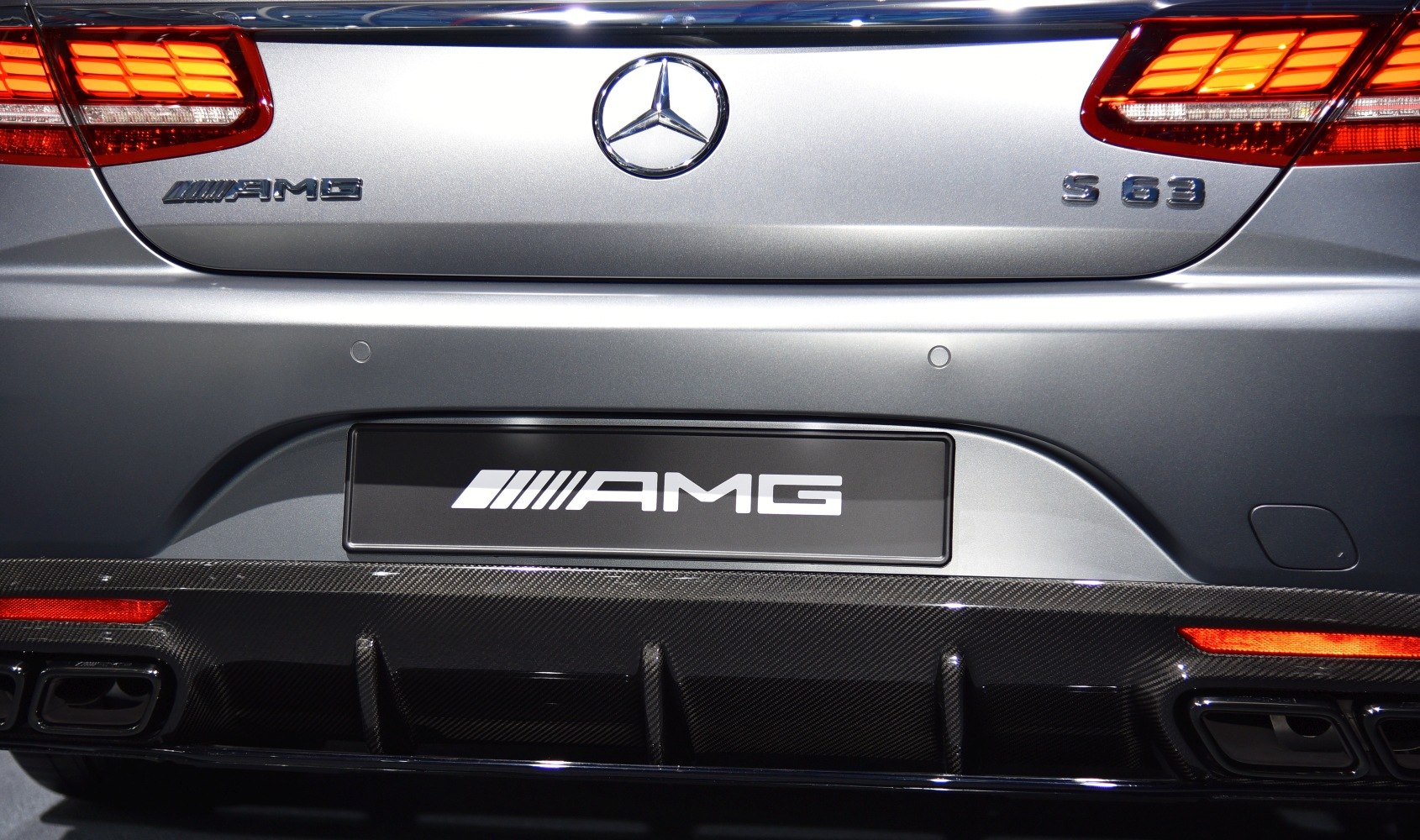 Rear AMG and S 63 badges with carbon fiber diffuser and lit taillights.