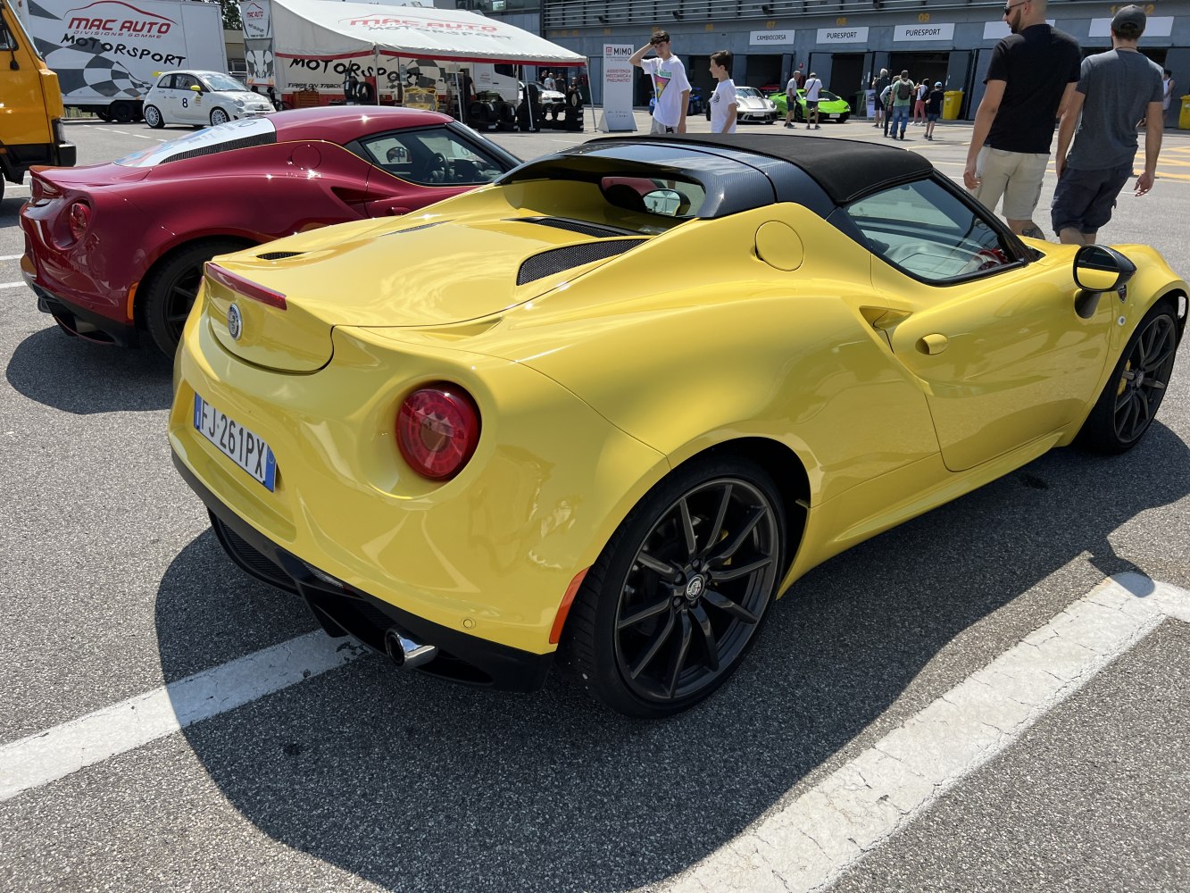 Rear and side view of a sporty convertible with distinctive round taillights.