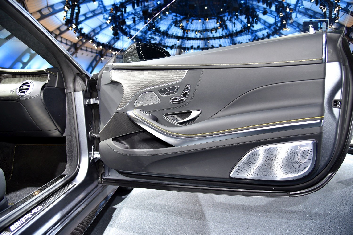 Luxury car door interior with control panel and Burmester speaker