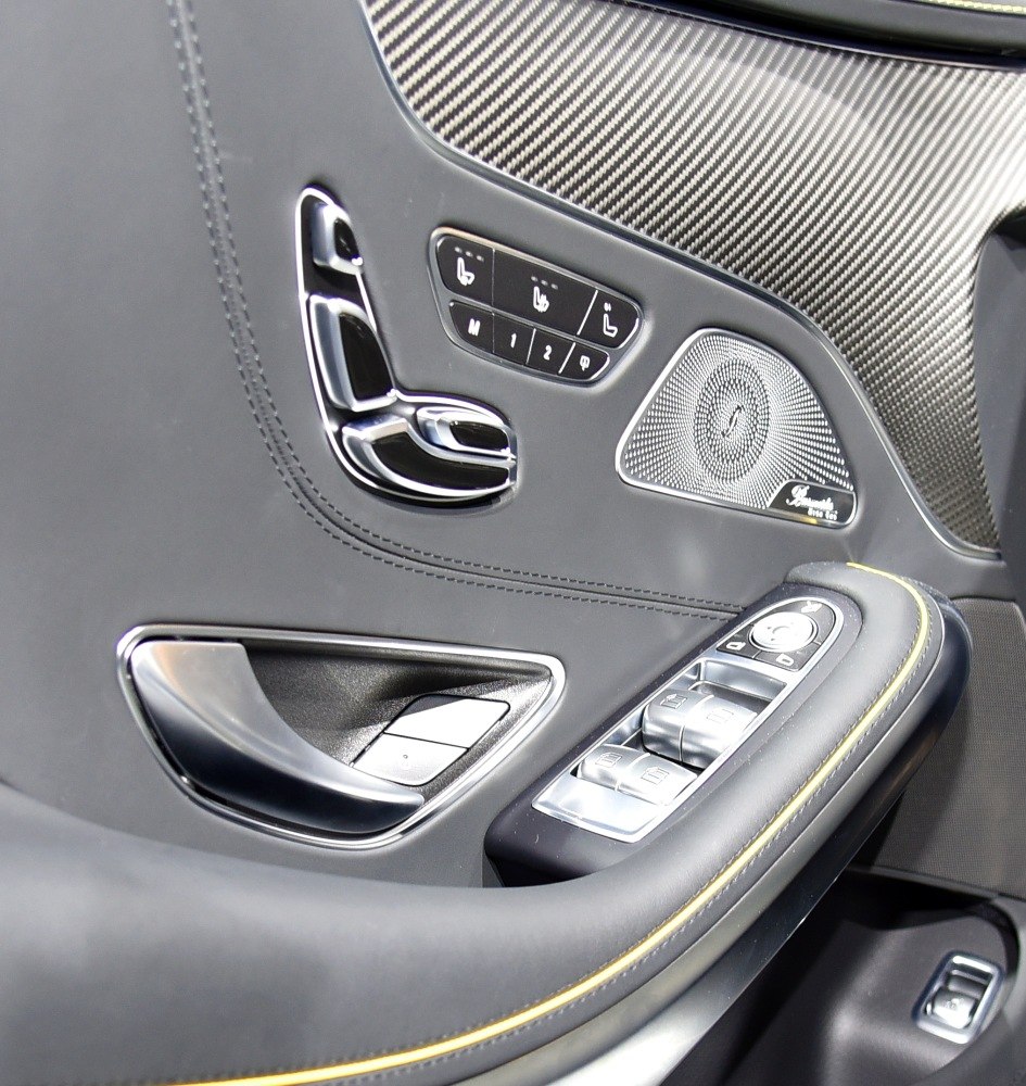 Close-up of door panel controls and Burmester speaker