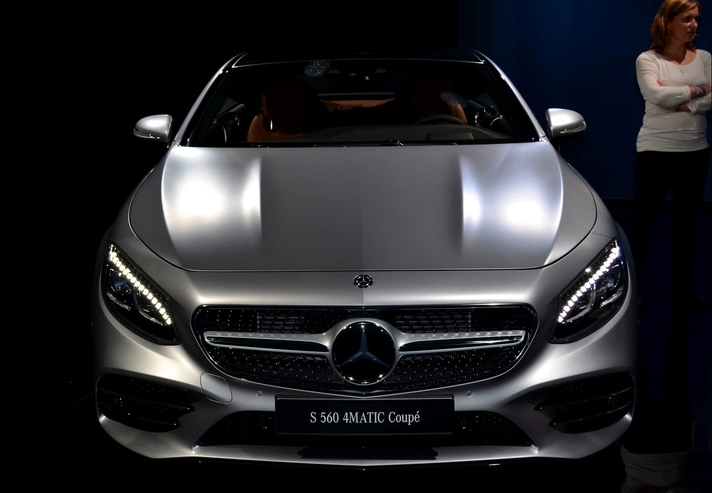 Front view of silver luxury coupé with LED headlights and grille