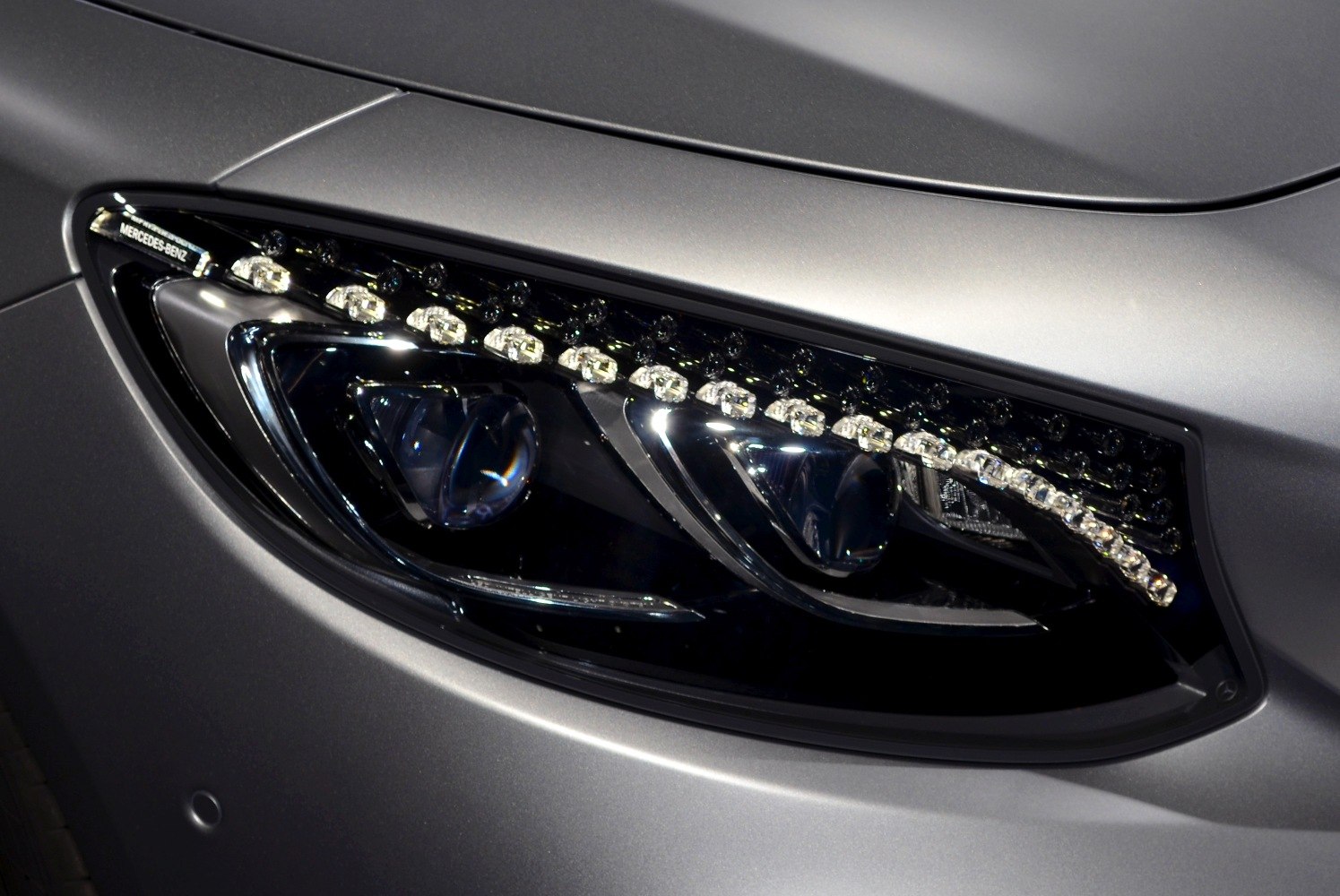 Close-up of advanced LED headlight with intricate design elements.