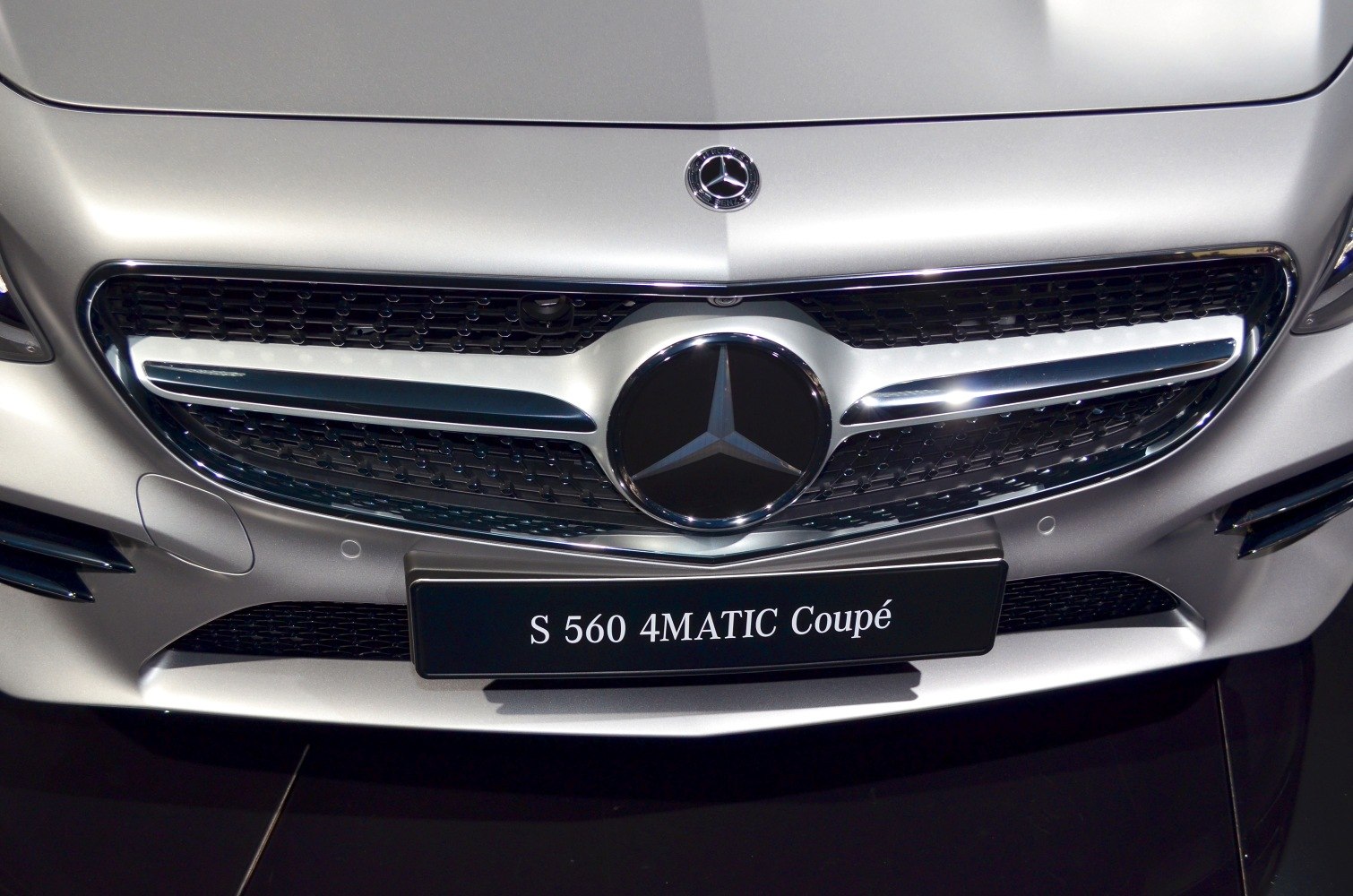 Close-up of luxury front grille and emblem.