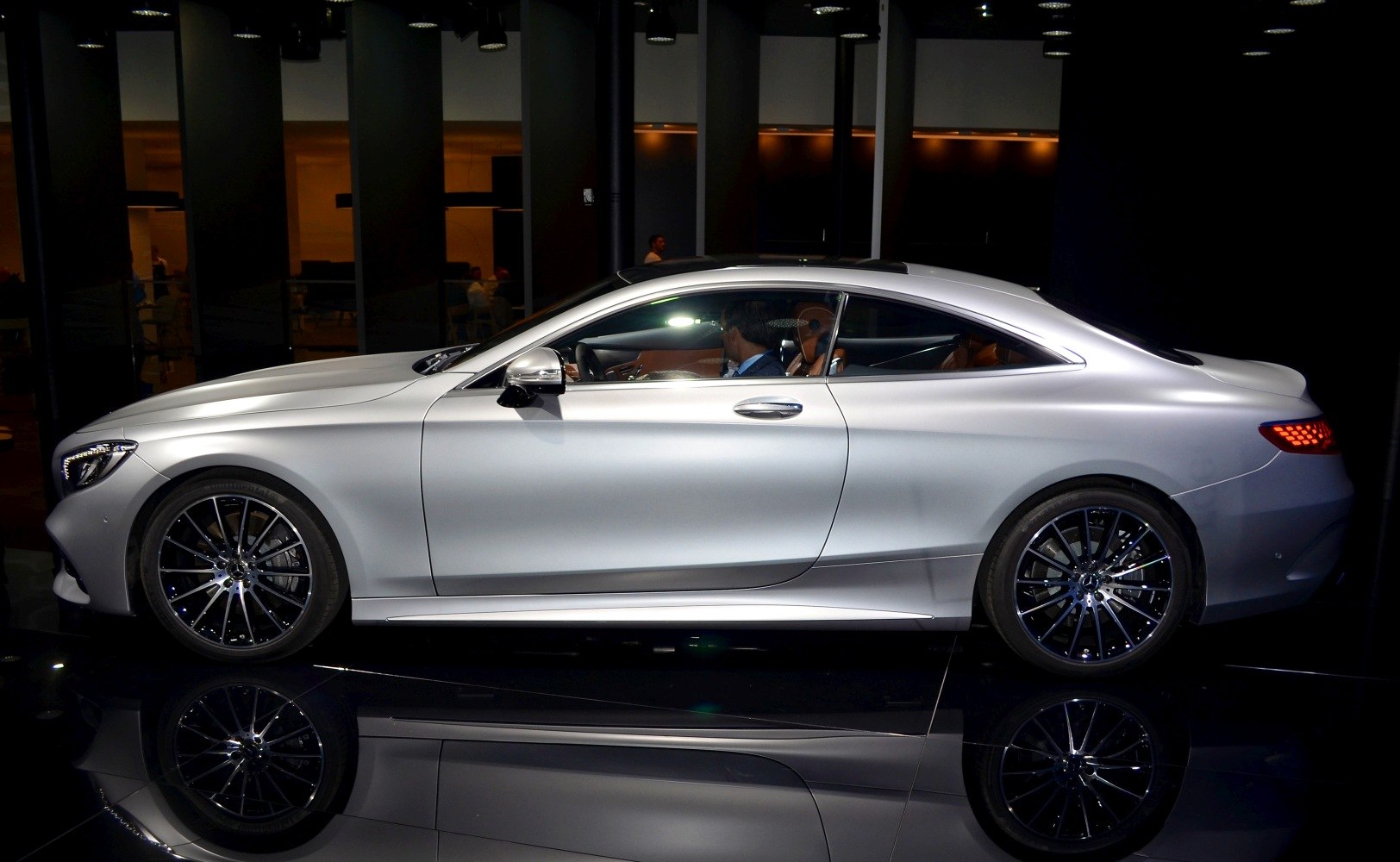 Luxury coupe side view with frameless windows and alloy wheels