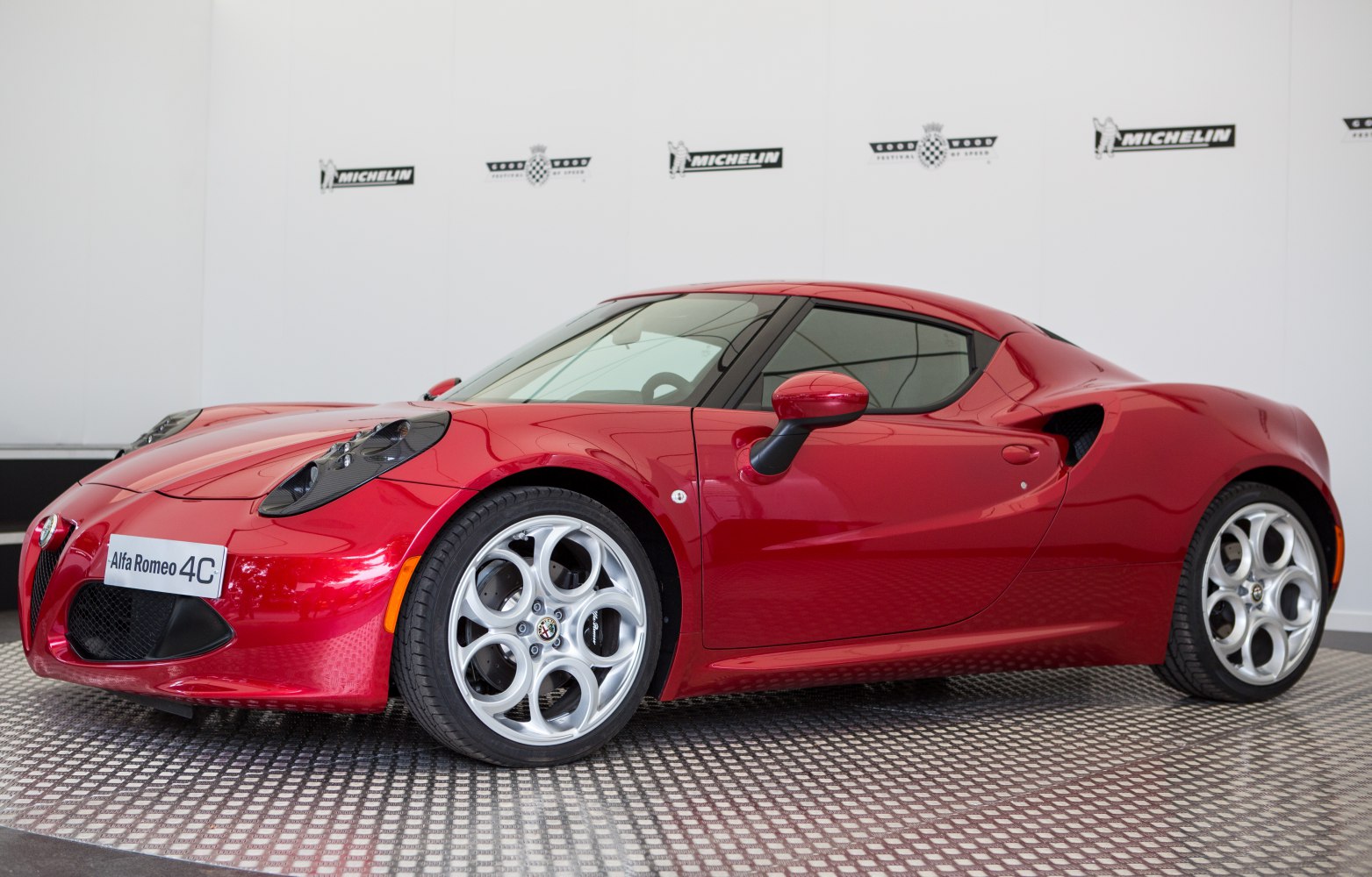 Red coupe with aerodynamic body and distinct circular alloy wheels