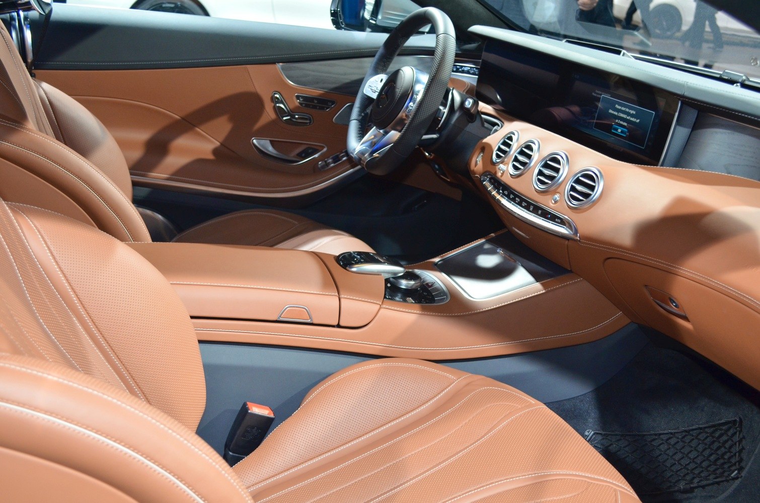 Luxury brown leather seats with advanced dashboard and multimedia display