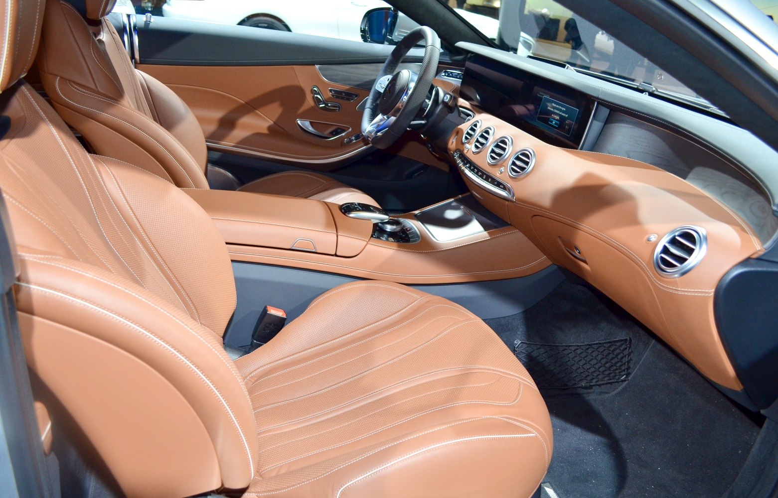 Brown leather seats and a modern dashboard with advanced controls