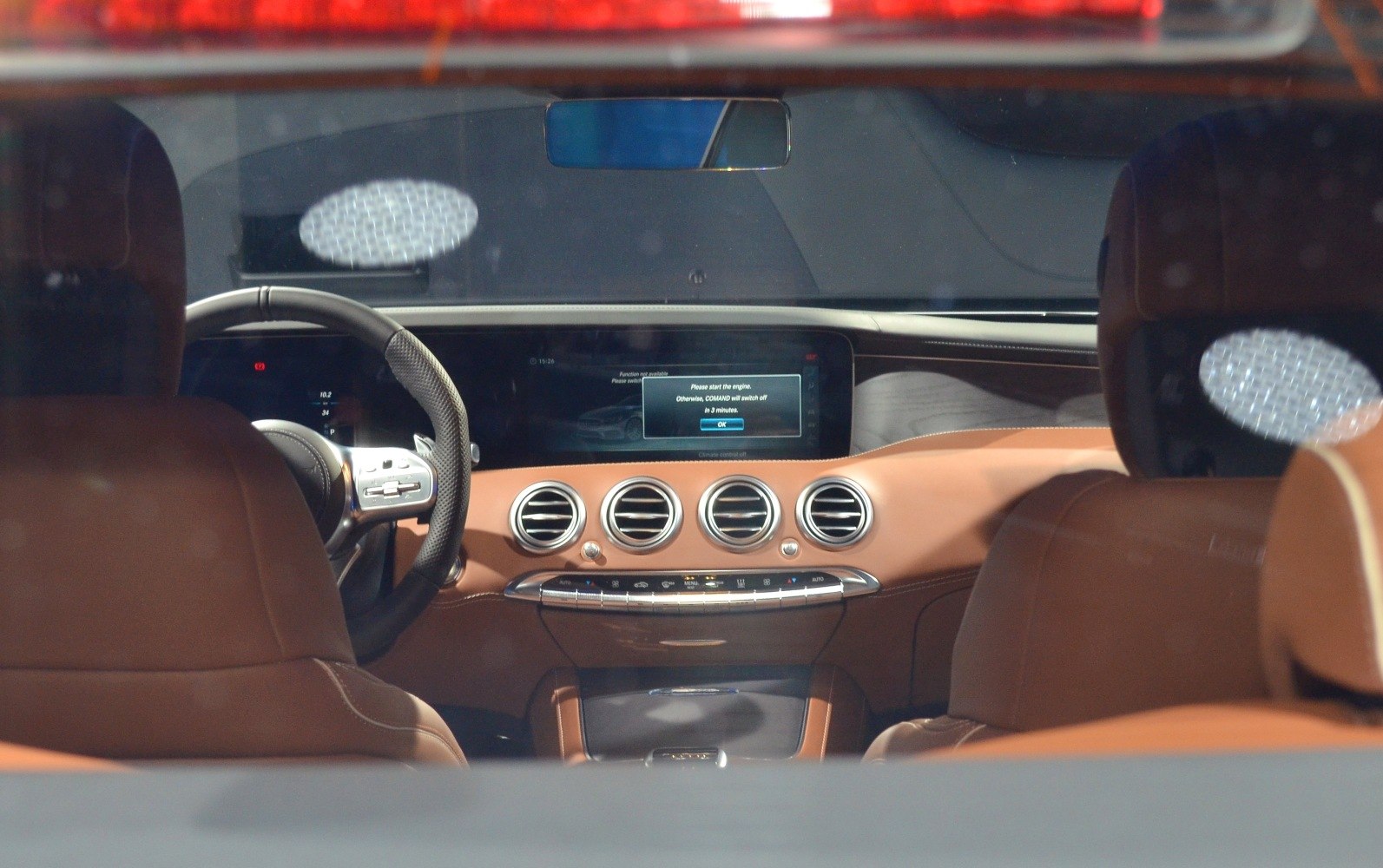 Luxury car interior with digital dashboard and four circular air vents