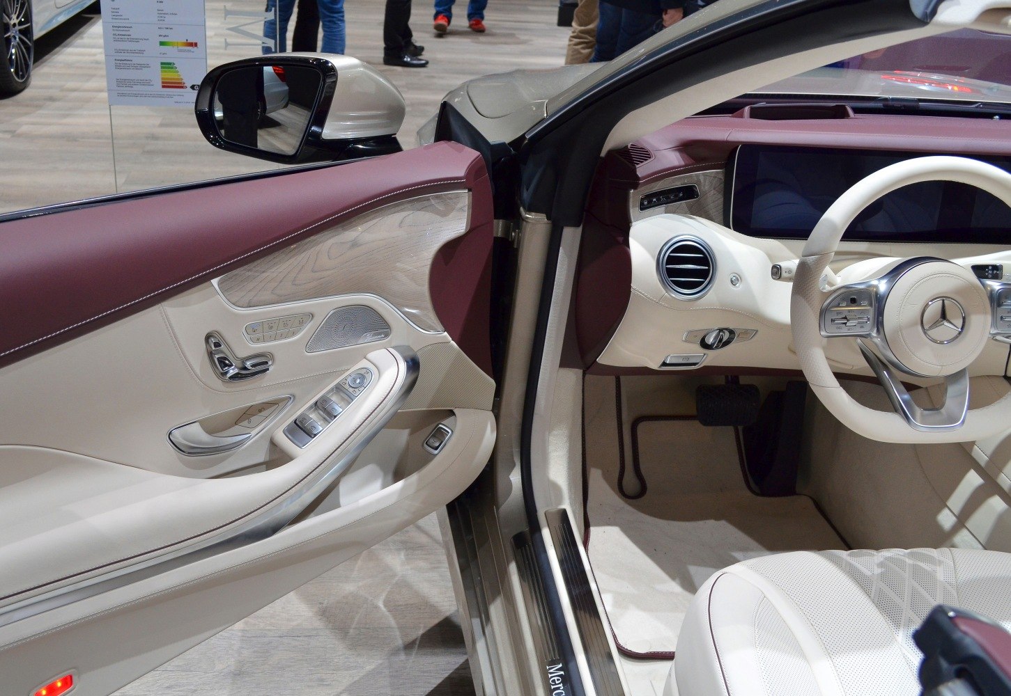 Luxury car interior with leather panels and advanced controls.