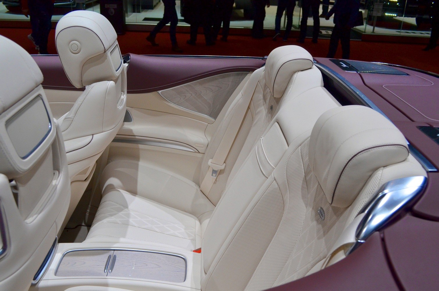 Beige luxury perforated leather rear seats with headrests and wood trim