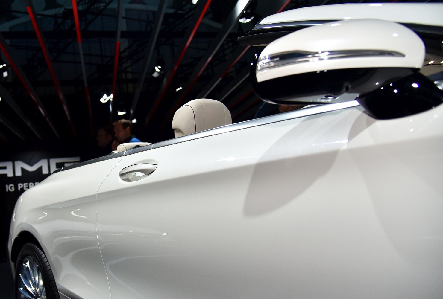 White car side door and mirror with beige headrest of a convertible