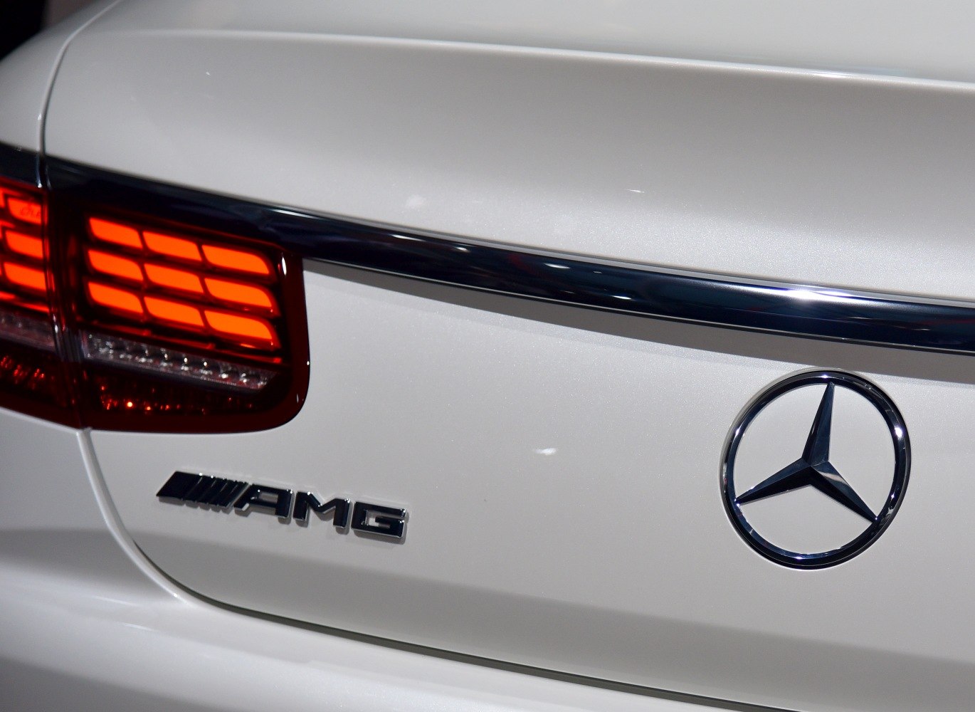 Close-up of AMG badge, star emblem, and LED tail light